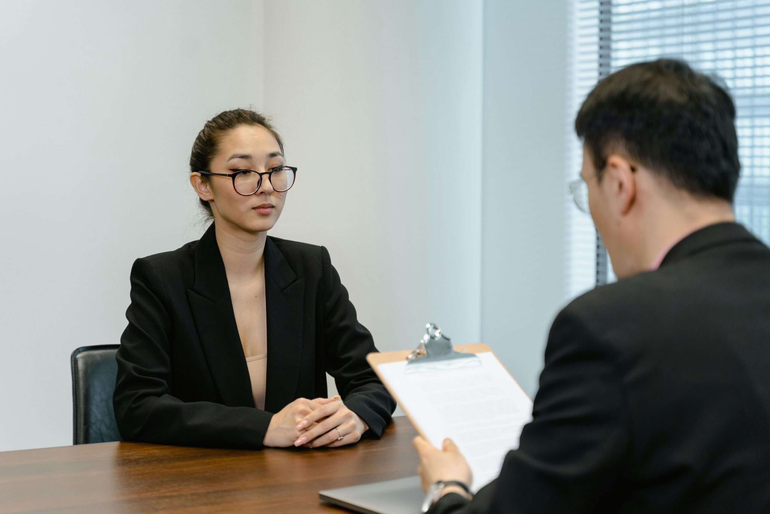 Business interview scene with professionals in office setting.